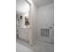 Hallway view into a bathroom with a shower, vanity, and linen closet at 30 Turner St # 202, Clearwater, FL 33756