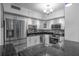 Modern kitchen featuring stainless steel appliances, mosaic backsplash, white cabinets and tile floors at 30 Turner St # 202, Clearwater, FL 33756
