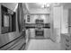 Modern kitchen featuring stainless steel appliances, mosaic backsplash, white cabinets and tile floors at 30 Turner St # 202, Clearwater, FL 33756