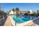 Community pool with a safety fence and a building with balconies in the background at 30 Turner St # 202, Clearwater, FL 33756