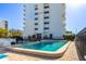 Community pool with clear water, surrounded by brick pavers and a building in the background at 30 Turner St # 202, Clearwater, FL 33756
