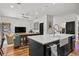 Open-concept living space with a modern kitchen that features a large island and stainless appliances at 3221 W Oakellar Ave, Tampa, FL 33611