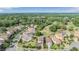 Aerial view of a residential area with luxury homes, lush greenery, and a golf course in the background at 3585 Torino Ln, Palm Harbor, FL 34683