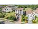 Aerial view of a two-story home with well-manicured landscaping in a neighborhood at 3585 Torino Ln, Palm Harbor, FL 34683
