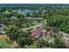 An aerial view of the clubhouse featuring well-manicured landscaping and views of the surrounding golf course at 3585 Torino Ln, Palm Harbor, FL 34683