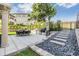 Outdoor kitchen and dining area with black rock border and steps in a well-maintained backyard at 3585 Torino Ln, Palm Harbor, FL 34683