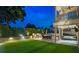 Enjoy the outdoor kitchen, dining area, lush lawn, and a covered patio on this home's lot at 3585 Torino Ln, Palm Harbor, FL 34683