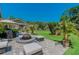 Outdoor patio featuring a fire pit, cushioned seating, manicured lawn, and mature trees at 3585 Torino Ln, Palm Harbor, FL 34683