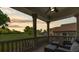 Balcony overlooking golf course, featuring stone columns, seating and ceiling fan at 3585 Torino Ln, Palm Harbor, FL 34683