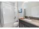 Well-lit bathroom features a shower-tub combo and a vanity with a granite countertop at 3585 Torino Ln, Palm Harbor, FL 34683