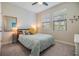 Cozy bedroom with a plush bed, natural light, and a decorative mirror at 3585 Torino Ln, Palm Harbor, FL 34683