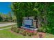 Innisbrook community sign framed by lush greenery and colorful flowers on a bright, sunny day at 3585 Torino Ln, Palm Harbor, FL 34683
