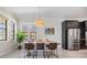 Bright dining room features modern lighting, black stainless steel appliances and ample windows at 3585 Torino Ln, Palm Harbor, FL 34683