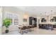 Open dining room with a rustic wood table, stylish lighting, and view into kitchen at 3585 Torino Ln, Palm Harbor, FL 34683