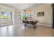 Bright dining room boasts tile floors, light fixture, and views to outdoor balcony at 3585 Torino Ln, Palm Harbor, FL 34683