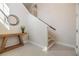 Clean entryway featuring a table with greenery and stairs leading to the upper level at 3585 Torino Ln, Palm Harbor, FL 34683