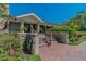 Exterior of the building with a stone facade, surrounded by vibrant landscaping and a paved walkway at 3585 Torino Ln, Palm Harbor, FL 34683