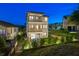 Three-story home boasts multiple balconies and meticulously maintained landscaping in a serene setting at 3585 Torino Ln, Palm Harbor, FL 34683