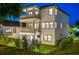 Beautiful exterior of a three-story home with multiple balconies and tasteful landscaping at 3585 Torino Ln, Palm Harbor, FL 34683