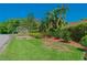 View of the Salamander Spa sign surrounded by lush landscaping and greenery at 3585 Torino Ln, Palm Harbor, FL 34683