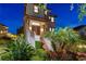 Inviting home features a tile roof, landscaped front yard, and grand stairway leading to the entrance at 3585 Torino Ln, Palm Harbor, FL 34683