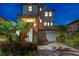 Elegant two-story residence with a tile roof, lush landscaping, and a welcoming driveway at 3585 Torino Ln, Palm Harbor, FL 34683