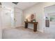 Hallway with carpeted floor, table with lamp, and doorway leading to another room at 3585 Torino Ln, Palm Harbor, FL 34683