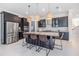 Modern kitchen with stainless steel appliances and a large center island with barstool seating at 3585 Torino Ln, Palm Harbor, FL 34683