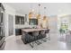 Modern kitchen with a large center island, barstool seating, and stainless steel appliances at 3585 Torino Ln, Palm Harbor, FL 34683