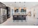 Modern kitchen with a large center island, barstool seating, and stainless steel appliances at 3585 Torino Ln, Palm Harbor, FL 34683