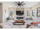 Bright living room with a modern fireplace, large windows, and neutral decor at 3585 Torino Ln, Palm Harbor, FL 34683