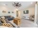 Bright living room featuring a ceiling fan and comfortable seating, perfect for relaxation and entertainment at 3585 Torino Ln, Palm Harbor, FL 34683