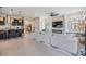 Beautiful open living room with fireplace and a view into a kitchen with barstool seating at 3585 Torino Ln, Palm Harbor, FL 34683