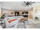 Spacious living room featuring a large sectional sofa, a ceiling fan, and views into kitchen at 3585 Torino Ln, Palm Harbor, FL 34683