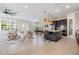 Spacious living room with access to dining room, and kitchen with island and barstool seating at 3585 Torino Ln, Palm Harbor, FL 34683