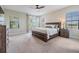 Spacious main bedroom with large windows, balcony access, and neutral color palette at 3585 Torino Ln, Palm Harbor, FL 34683