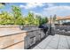 Stylish outdoor kitchen with granite countertops and stainless steel appliances, ideal for al fresco dining at 3585 Torino Ln, Palm Harbor, FL 34683