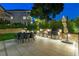 Beautiful outdoor kitchen includes built-in grill, dining area, and manicured landscaping at 3585 Torino Ln, Palm Harbor, FL 34683