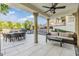 Covered outdoor patio offers seating, a dining table, and elegant pillars at 3585 Torino Ln, Palm Harbor, FL 34683