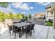 Inviting outdoor patio featuring dining table and seating with views of the landscaped backyard at 3585 Torino Ln, Palm Harbor, FL 34683