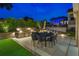 Outdoor patio features a dining area with an outdoor kitchen and grill, perfect for entertaining at night at 3585 Torino Ln, Palm Harbor, FL 34683