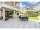 Covered patio with outdoor seating area, large tile flooring, and wrought iron balcony above at 3585 Torino Ln, Palm Harbor, FL 34683