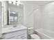 Bright bathroom with a shower-tub combination and a granite-topped vanity and plenty of light at 37202 Clinch Cir, Zephyrhills, FL 33540