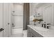 Well-lit bathroom with a shower-tub combo, granite countertop, and modern fixtures at 37202 Clinch Cir, Zephyrhills, FL 33540