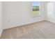 A bright, carpeted bedroom showcasing the window and closet at 37202 Clinch Cir, Zephyrhills, FL 33540