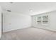 A bright bedroom featuring two windows, plush carpeting, and neutral paint ready for personalization at 37202 Clinch Cir, Zephyrhills, FL 33540