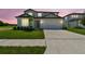 Beautiful two-story home with well-maintained landscaping, a spacious driveway, and charming architectural details at 37202 Clinch Cir, Zephyrhills, FL 33540