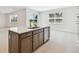 Kitchen island with sink, dishwasher and generous counter space adjacent to a bright living area at 37202 Clinch Cir, Zephyrhills, FL 33540