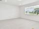 Bright, open living space with large window and view of the backyard at 37202 Clinch Cir, Zephyrhills, FL 33540