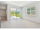 Bright living area with a sliding glass door to the patio and views of the backyard at 37202 Clinch Cir, Zephyrhills, FL 33540